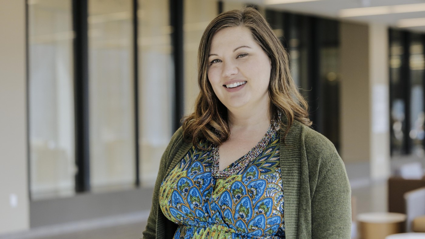 A smiling woman in a VA facility.
